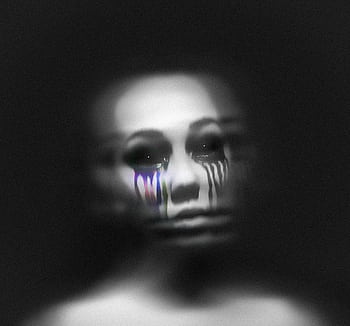 A blurred grayscale portrait with colorful tear-like streaks, evoking emotions and mystery. HD wallpaper