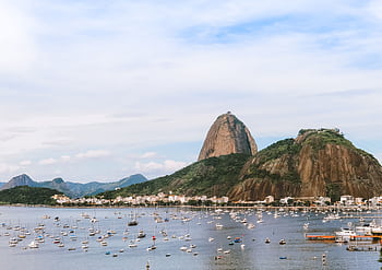 Captivating view of Sugarloaf Mountain in Rio de Janeiro with boats in the bay under a clear sky. HD wallpaper