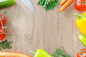 Colorful vegetables and herbs arranged on a rustic wooden surface. HD wallpaper