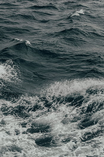 Captivating view of ocean waves crashing dramatically, set in monochrome tones for an artistic feel. HD phone wallpaper