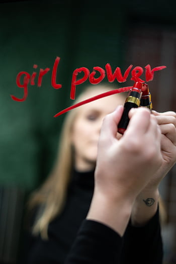Close-up of 'girl power' written with lipstick on mirror symbolizing empowerment and feminism. HD phone wallpaper