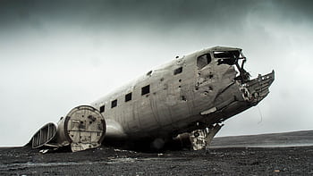 A dramatic of a derelict plane wreck on a remote, deserted landscape. HD wallpaper