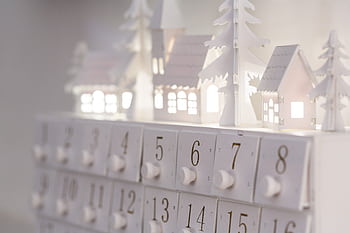 Beautiful minimalist advent calendar with illuminated houses and numbers for winter decor and festive ambiance. HD wallpaper