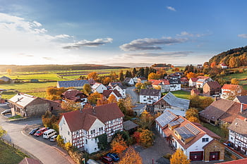 Charming aerial view of a rural village in autumn with vivid colors and clear skies. HD wallpaper