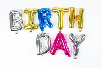 Festive metallic balloon letters spelling 