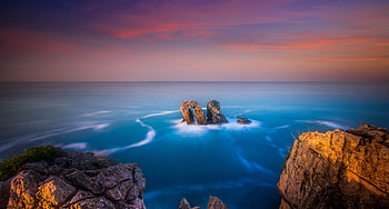 Coast, rocks, blue sea, skyline, sunset HD wallpaper