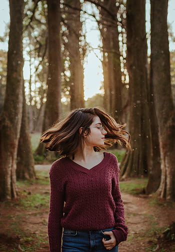 A young woman twirls in a forest, capturing the essence of nature and dom. HD phone wallpaper