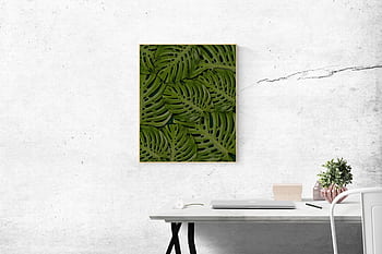 A stylish minimalist office setting featuring a framed green leaf artwork and sleek white desk. HD wallpaper