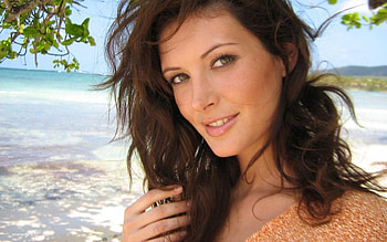 April Bowlby, sea, leaves, sand, portrait , pretty eyes, brunette, pale orange top, beach HD wallpaper