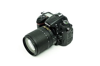 Close-up of a Nikon DSLR camera with lens on a white background, ideal for graphy enthusiasts. HD wallpaper