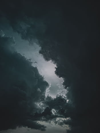 Moody and dramatic cloudscape captured during a thunderstorm, featuring dark clouds. HD phone wallpaper