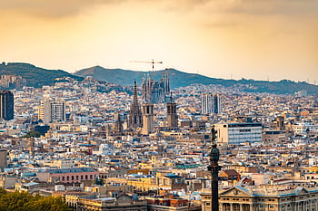 A breathtaking aerial view of Barcelona featuring the iconic Sagrada Familia at sunset. HD wallpaper