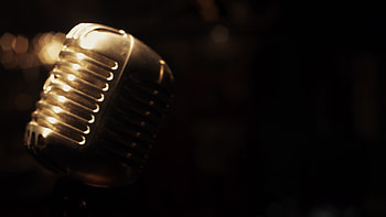 Gleaming metal micro, Retro club setting, Spotlights on stage, Vintage ambiance HD wallpaper