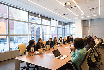 A diverse team of business professionals collaborating in a modern meeting room. HD wallpaper