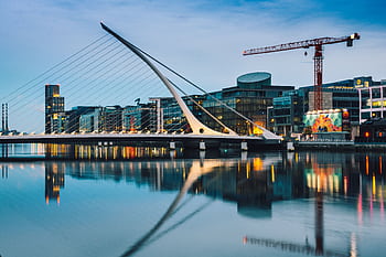 Stunning twilight view of the Samuel Beckett Bridge and Dublin skyline reflecting in the River Liffey. HD wallpaper