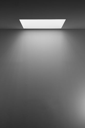 Black and white minimalist of a ceiling light casting shadows on a blank wall. HD phone wallpaper