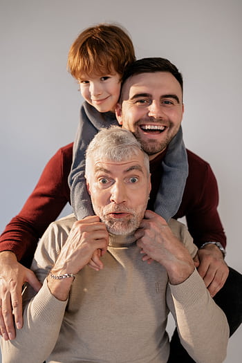 A joyful moment captured with a grandfather, father, and son showing happiness and bonding. HD phone wallpaper