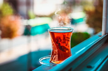 A steaming cup of Turkish tea on a windowsill with blurred background in Gaziantep. HD wallpaper