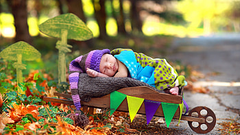 Cute Newborn Child Is Sleeping On Wood Cart Covering With Colorful Cloth In Blur Background Cute HD wallpaper