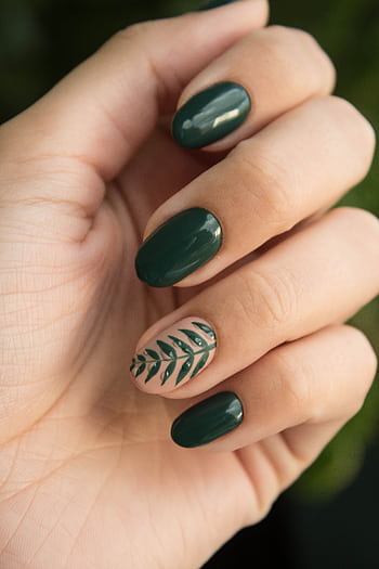 Close-up of a stylish green manicure with a leaf design, showcasing glossy fingernails and natural skin tone. HD phone wallpaper