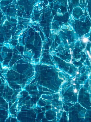 Abstract view of sunlit ripples in a clear blue swimming pool featuring tile patterns. HD phone wallpaper