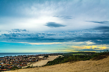 Sand, landscape, coast, city, clouds, sky HD wallpaper