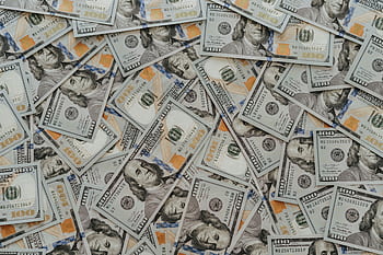 US hundred dollar bills scattered in abundance creating a financial backdrop. HD wallpaper