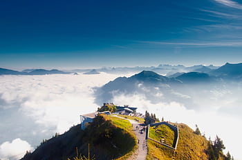A stunning view from Stanserhorn in Switzerland, showcasing clouds, mountains, and scenic landscapes. HD wallpaper