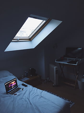 A modern home office setup in a cozy attic bedroom with skylight. HD phone wallpaper