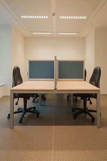 Contemporary office space featuring partitioned desks and ergonomic chairs. HD phone wallpaper