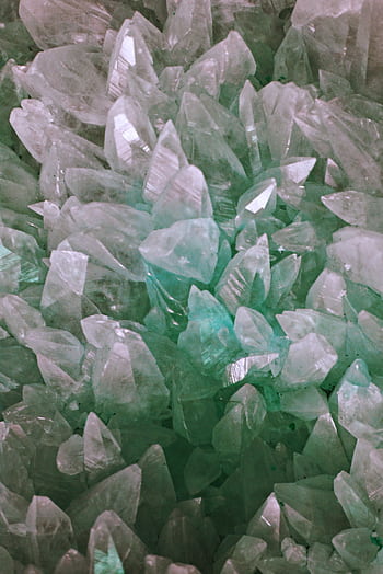 Close-up of shimmering aquamarine quartz crystals showcasing detail and translucency. HD phone wallpaper
