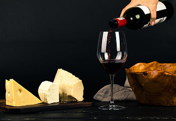 Enjoy a fine dining experience with red wine and gourmet cheese displayed elegantly. HD wallpaper