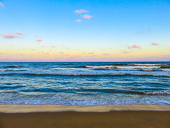 Peaceful ocean waves at sunset, a perfect seascape for relaxation. HD wallpaper