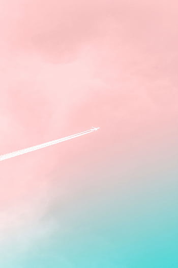 A serene view of an airplane soaring through a pastel pink and blue sky, leaving a contrail. HD phone wallpaper