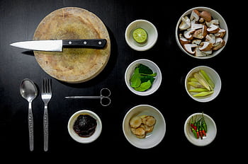 Aerial view of various cooking ingredients and utensils on dark background. HD wallpaper