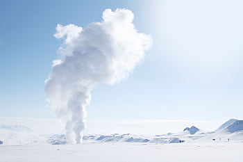 Snow-covered Icelandic landscape featuring geothermal steam plume against clear sky. HD wallpaper