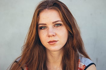 Stunning close-up portrait of a young woman with red hair and expressive eyes. HD wallpaper