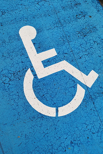 Parking space with wheelchair symbol on blue background for accessibility. HD phone wallpaper