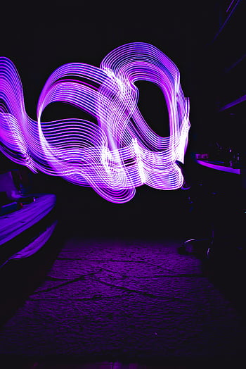 Dynamic purple light painting creating vivid waves on a dark backdrop, perfect for abstract designs. HD phone wallpaper