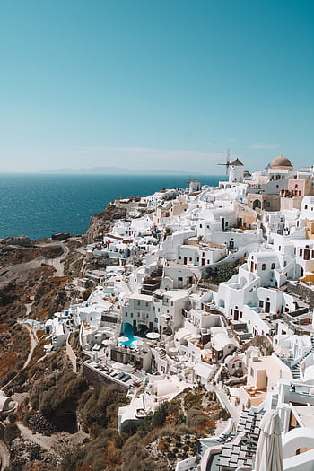 Explore Santorini's stunning white buildings against the azure sea, a perfect travel destination. HD phone wallpaper