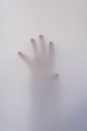 Eerie of a hand reaching through a foggy surface, evoking mystery and suspense. HD phone wallpaper