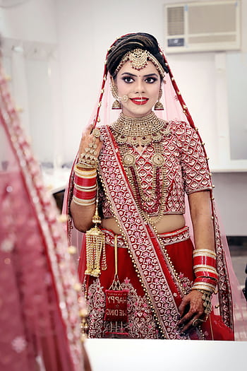 Stunning bride in traditional red and gold wedding attire, captured in a classic portrait style. HD phone wallpaper