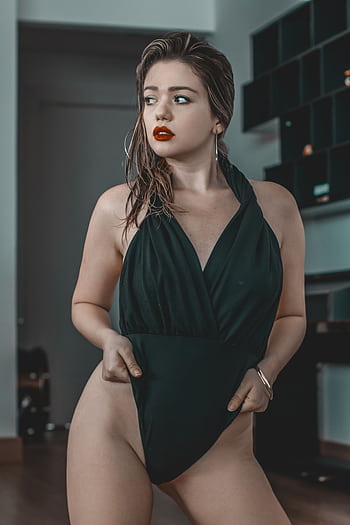 Elegant woman in a black swimsuit posing indoors with a stylish and alluring look. HD phone wallpaper