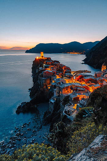 Stunning sunset view of Vernazza village illuminating the coast in Cinque Terre, Italy. HD phone wallpaper