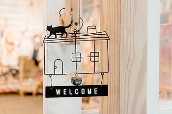 Interior design wooden door decoration featuring a welcome sign with cat silhouette. HD wallpaper