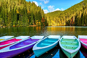 Multi-colored boats at the pier, fall, pier, lake, Romania, mountain, serenity, tranquil, reflection, boats, view, autumn, forest, dock HD wallpaper