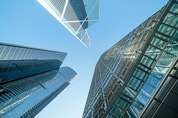 Modern skyscrapers captured from below, showcasing Hong Kong's urban architecture. HD wallpaper