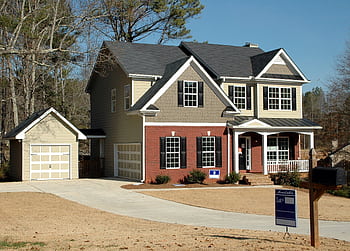 Beautiful two-story home with garage in a serene neighborhood, perfect for families. HD wallpaper