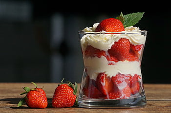 Delicious strawberry dessert layered with cream in a glass, perfect for a summer treat. HD wallpaper