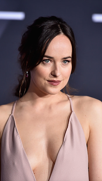 Dakota Johnson, Mesmeric gaze, Enchanting elegance, genic charm HD phone wallpaper
